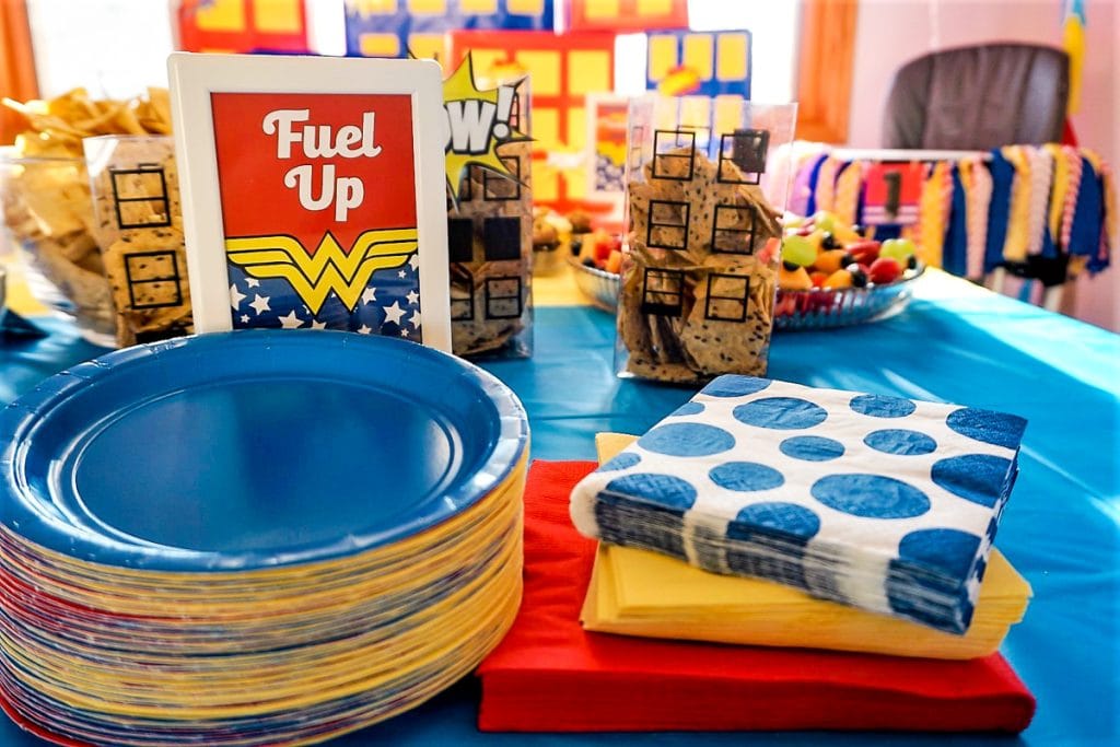 Fuel Up party sign on Wonder Woman party table